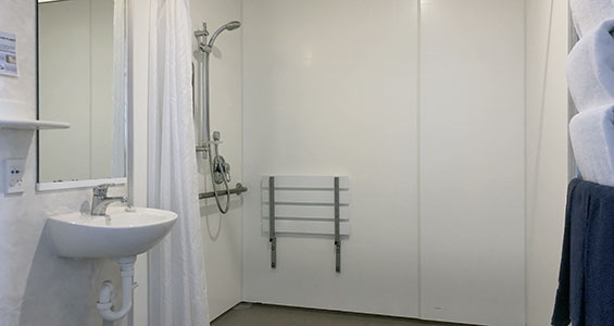 walk-in shower of Bowen one-bedroom suite with handrails
